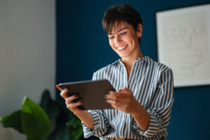 Portrait of a Beautiful Modern Business Woman Using Tablet in Her Office