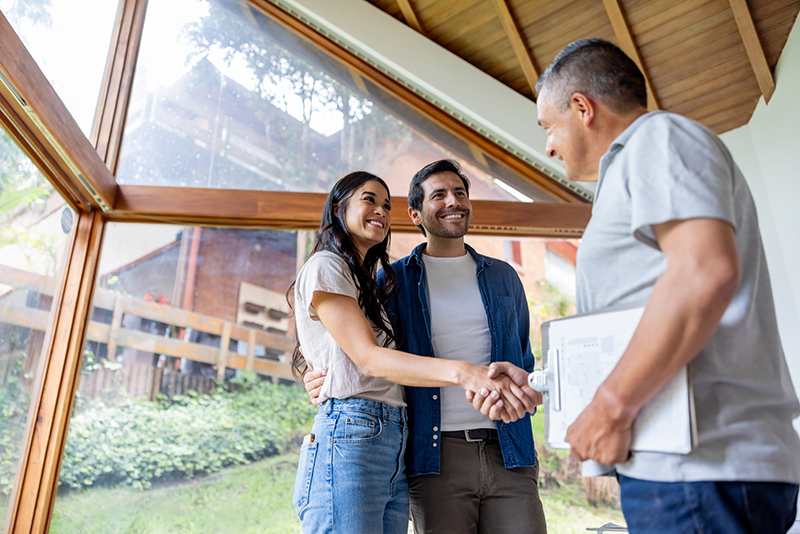 Building contractor greeting clients interested in remodeling
